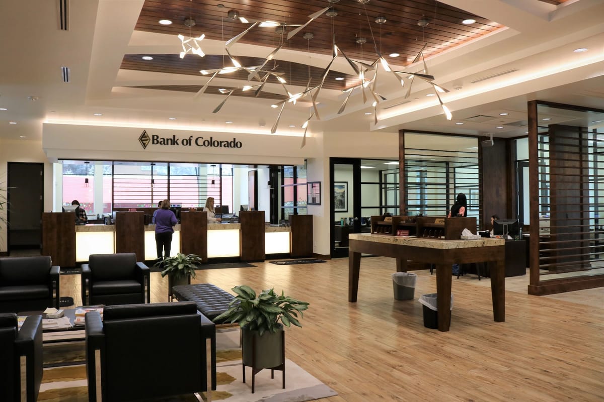 The completed Bank of Colorado banking hall with teller stations, timber ceiling detail and lounge seating