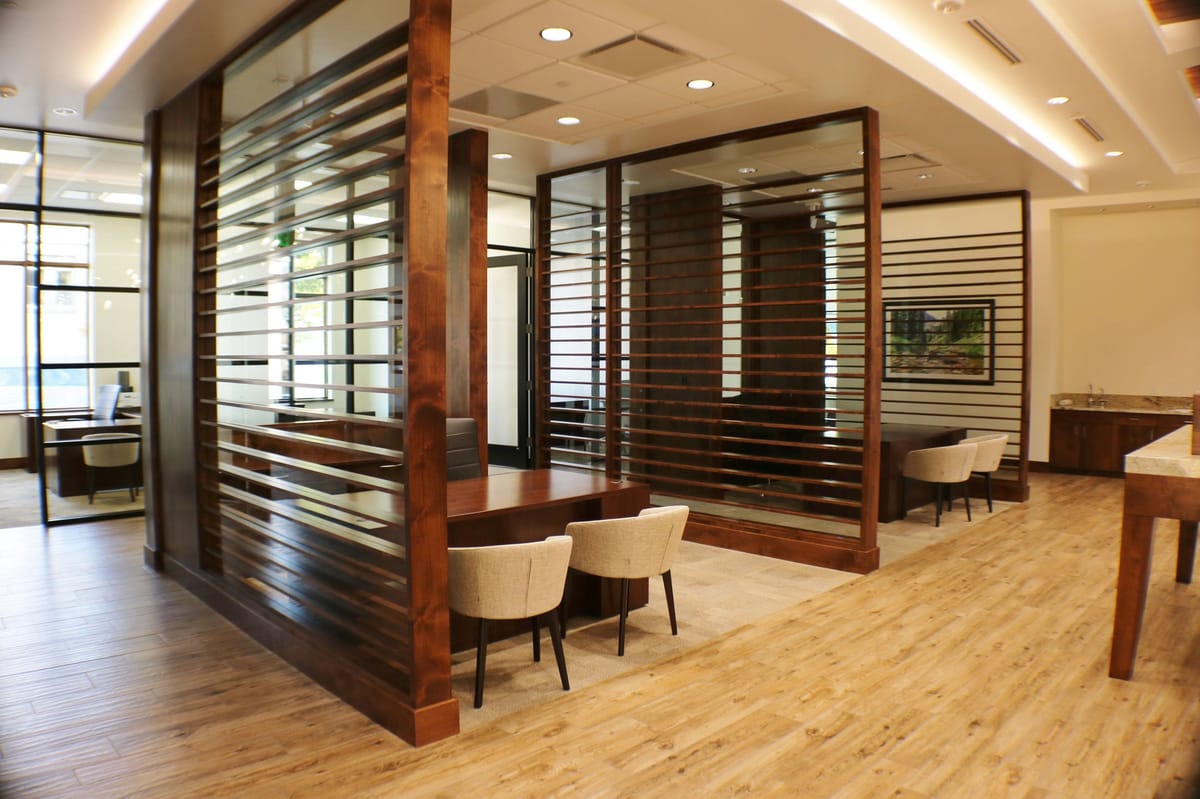 The light-filled interior of the Bank of Colorado, with timber screens and glass-walled offices