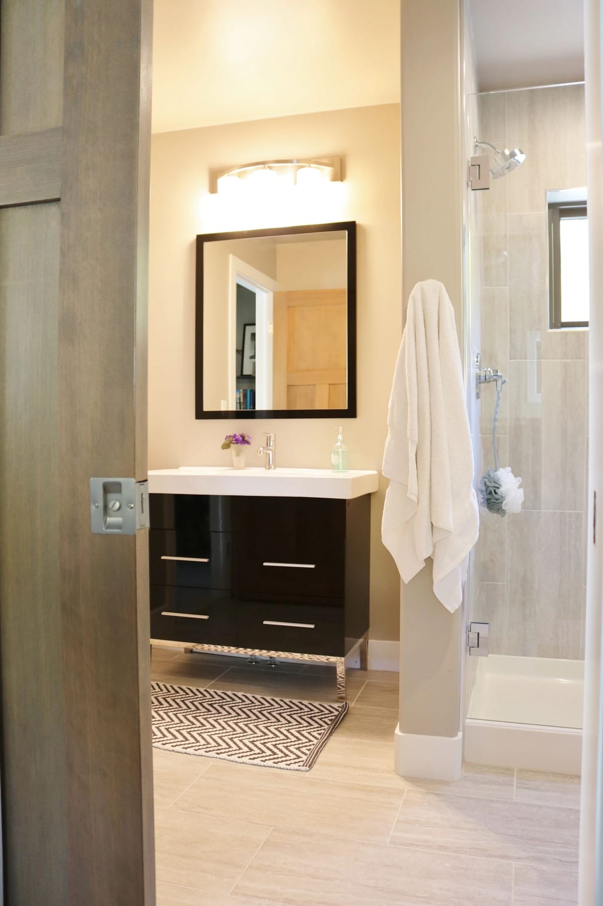 A remodeled bathroom with a floating vanity and glass shower