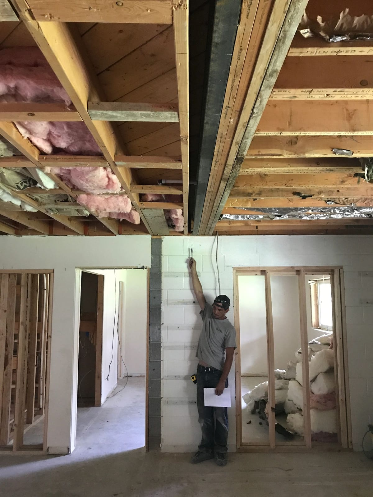 A can-light layout marked out on open ceiling framing before drywall
