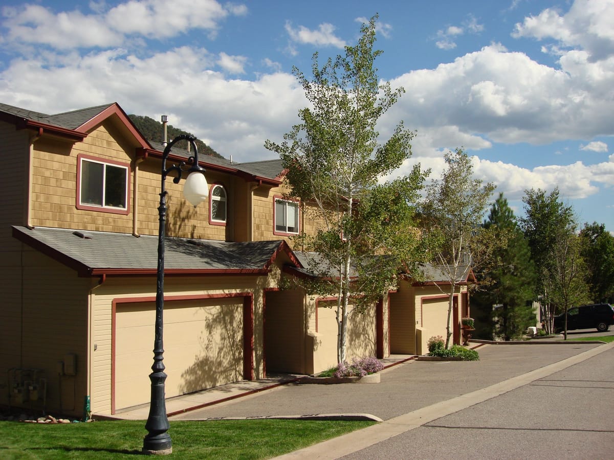 A row of townhomes on a tree-lined street in Glenwood Springs