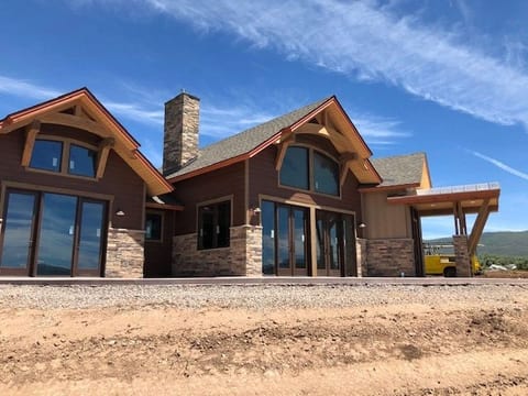 A stone-and-timber lodge home with a gabled entry