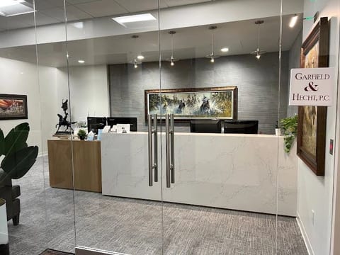 A law-office reception area with a stone desk and patterned feature wall