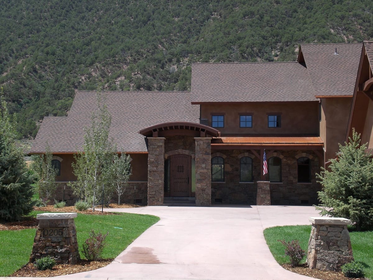 The arched stone entry of a large custom mountain home