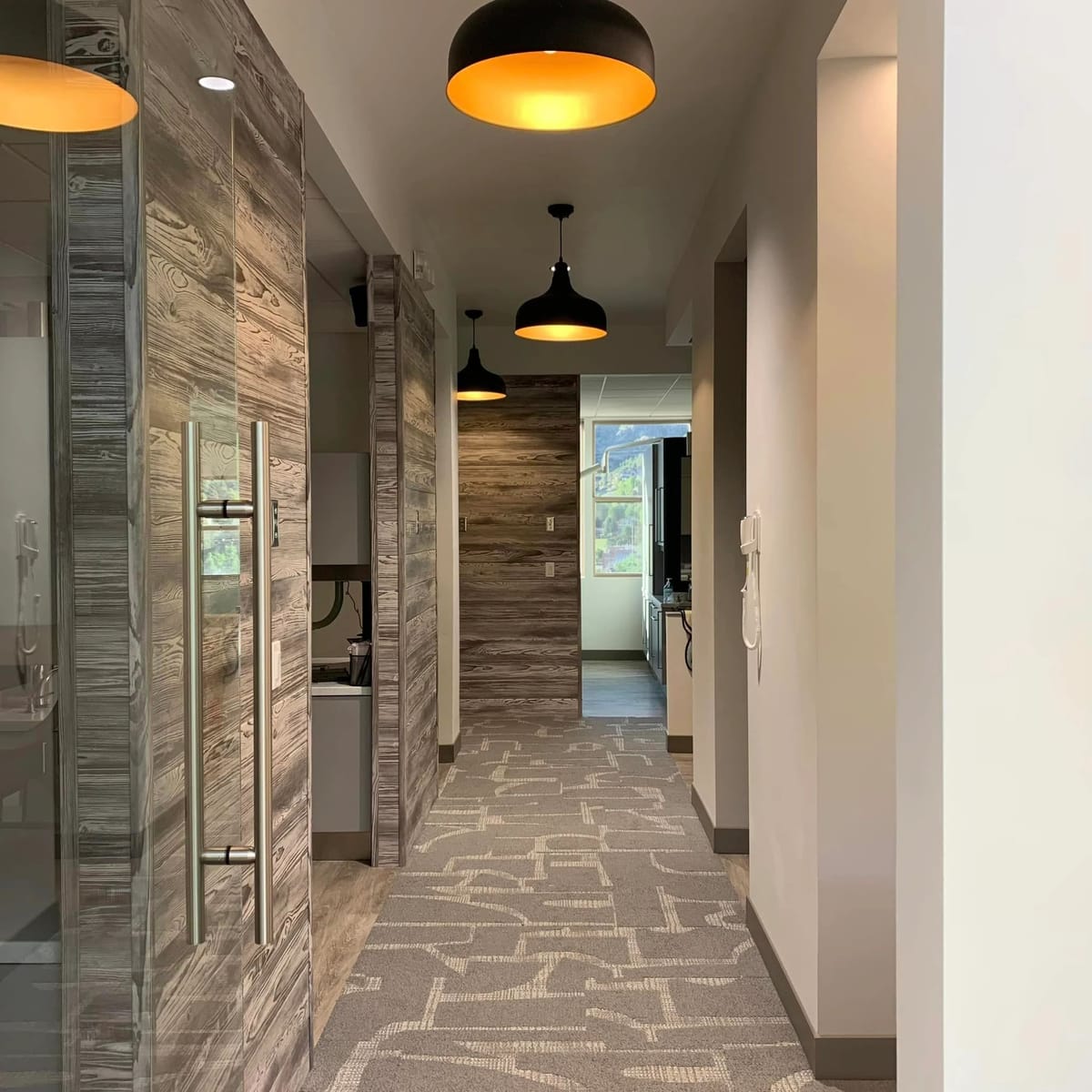 A dental practice corridor in reclaimed timber and warm lighting