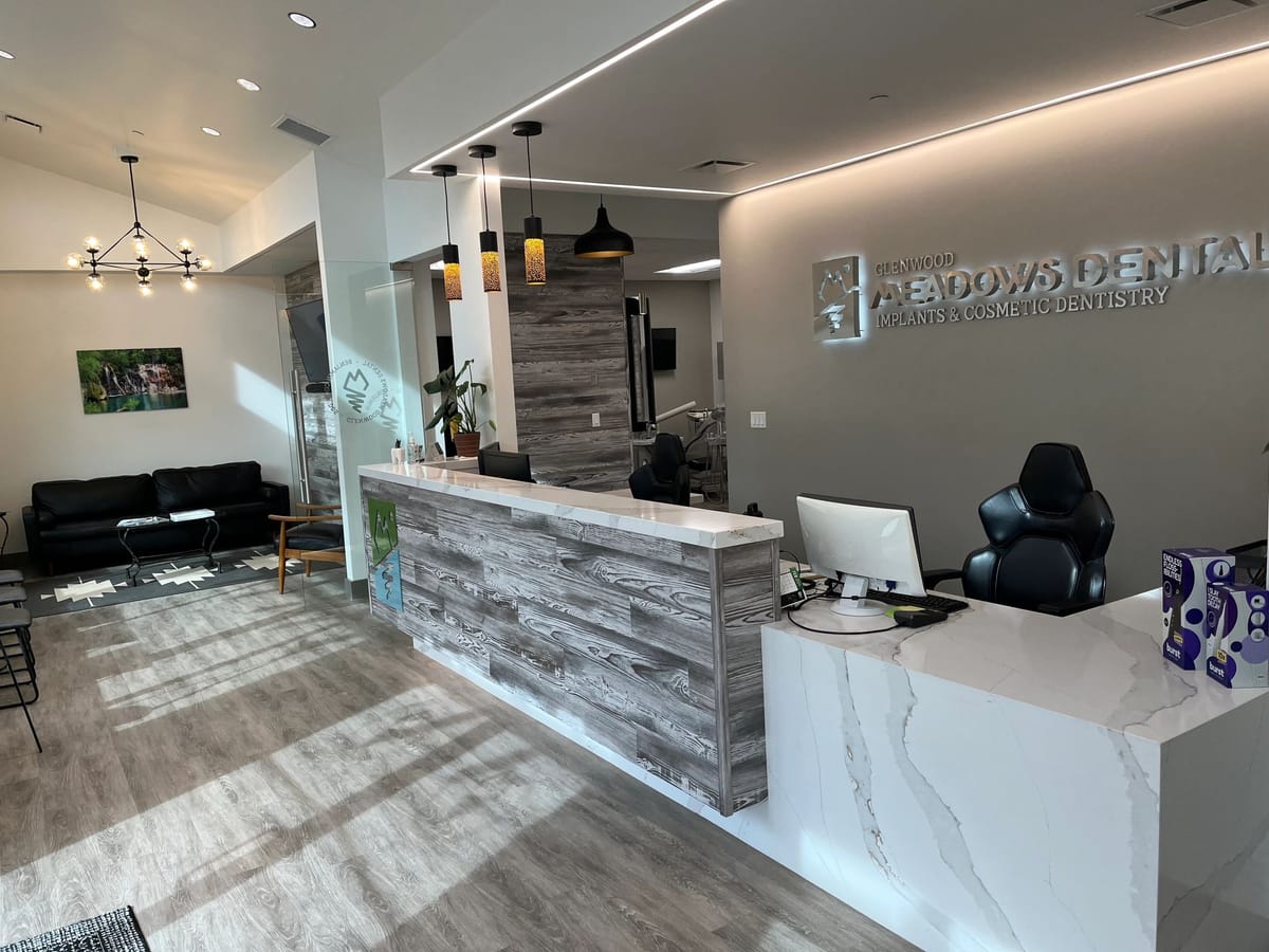 A finished dental practice reception desk in stone and reclaimed timber
