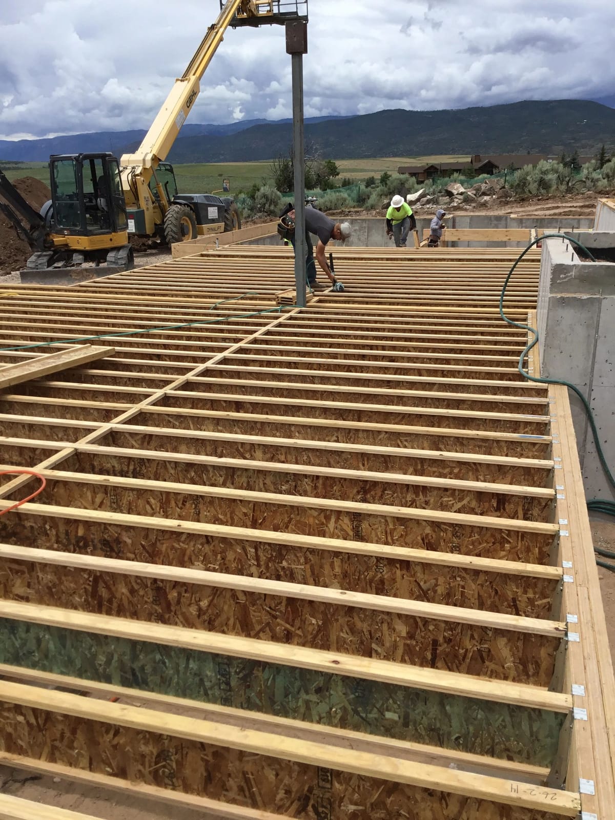 Floor joists and sheathing being set on a new structure
