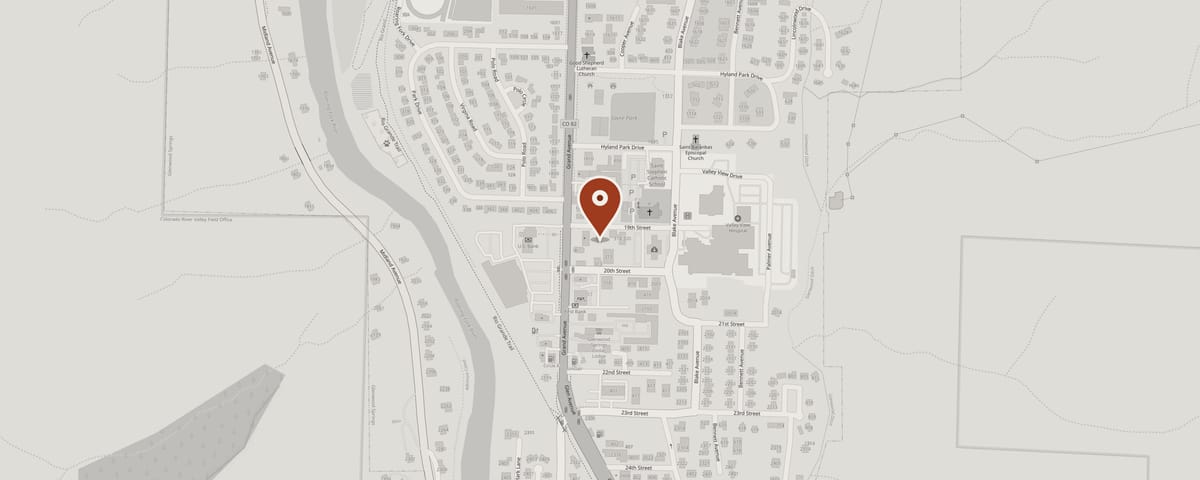 Street map of south Glenwood Springs with a red pin marking the D.M. Neuman Construction office on 19th Street, just east of Grand Avenue