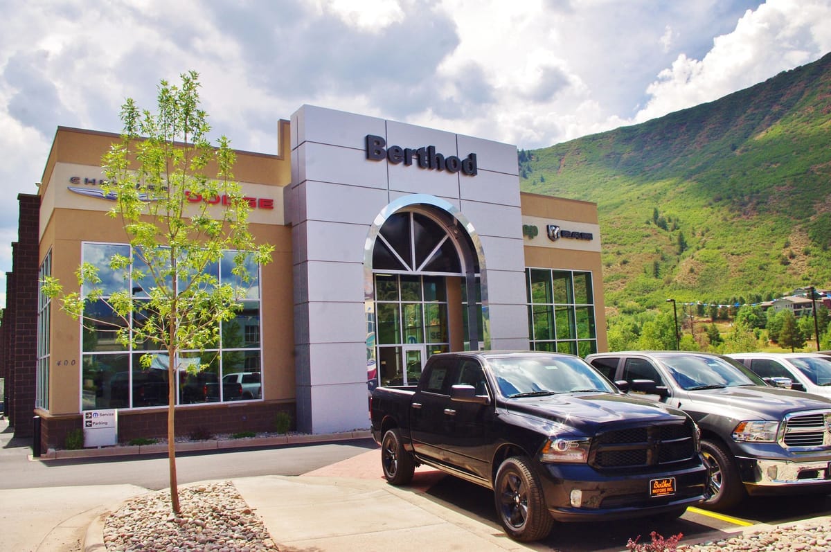 The Berthod Motors dealership in Glenwood Springs with the green hillside rising behind it