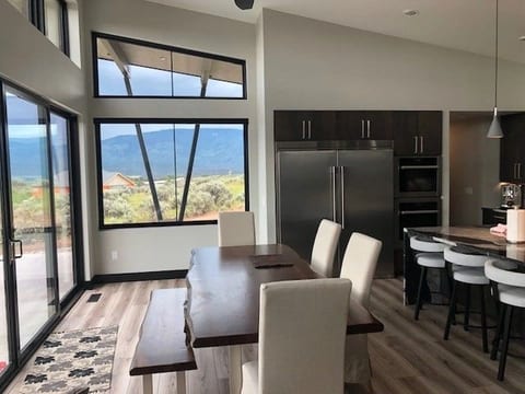 A great room with floor-to-ceiling glass looking onto the Colorado hills