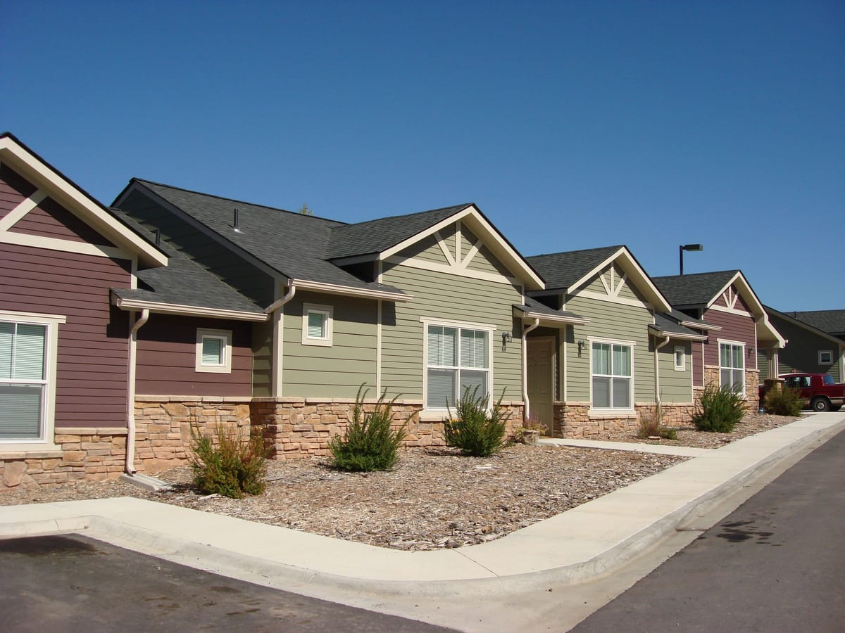 A completed multi-family senior housing development with landscaped walkways